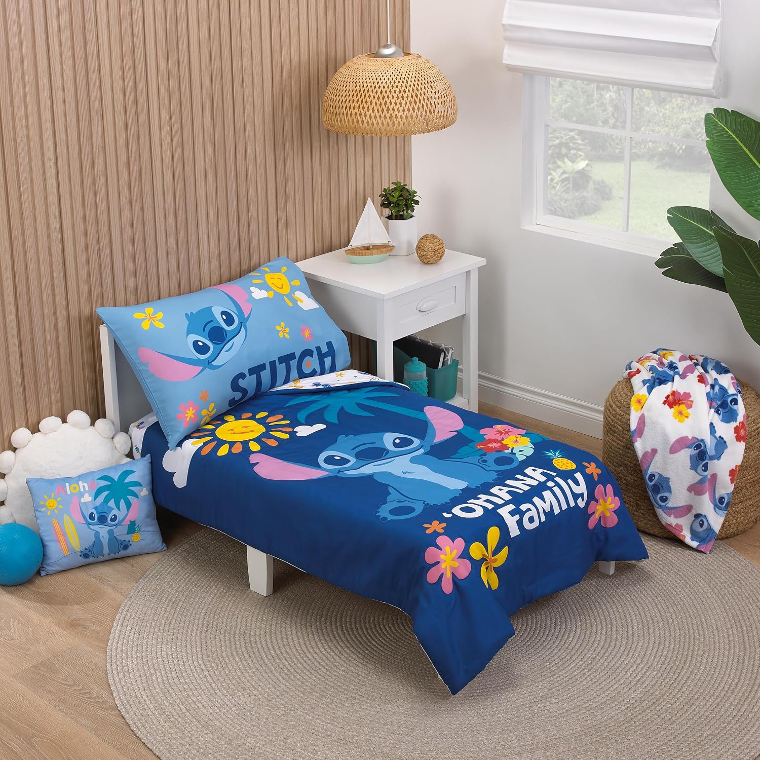 NoJo Disney S is for Stitch 4 Piece Toddler Bed Set Includes a Comforter, Fitted Bottom Sheet, Flat top Sheet, and Reversible Pillowcase. Features Fun and Playful Stitch in a Tropical Pattern